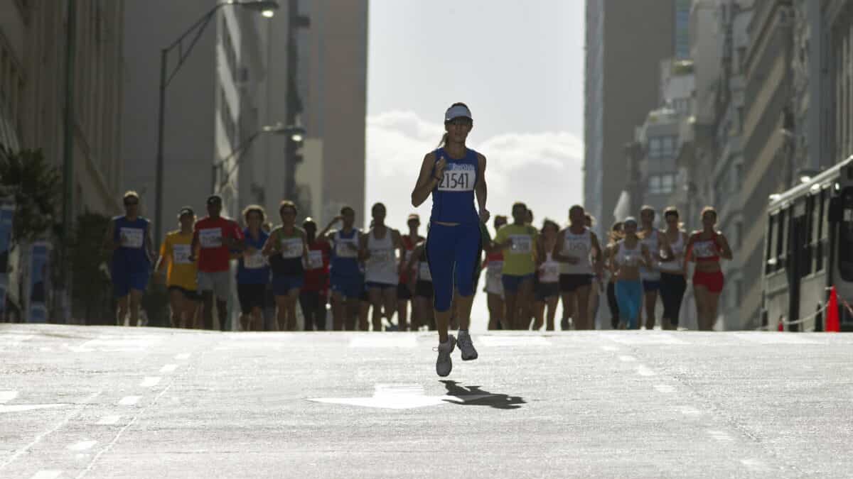 Woman running in front of pack in marathon