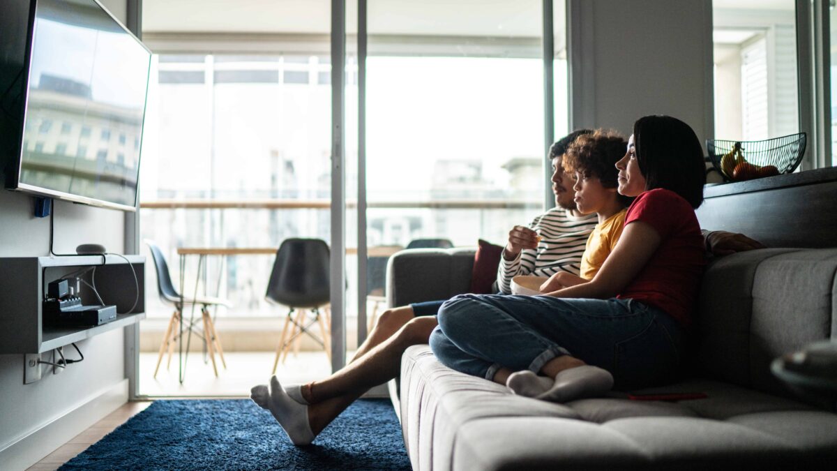 A family watches tv using Roku at home.